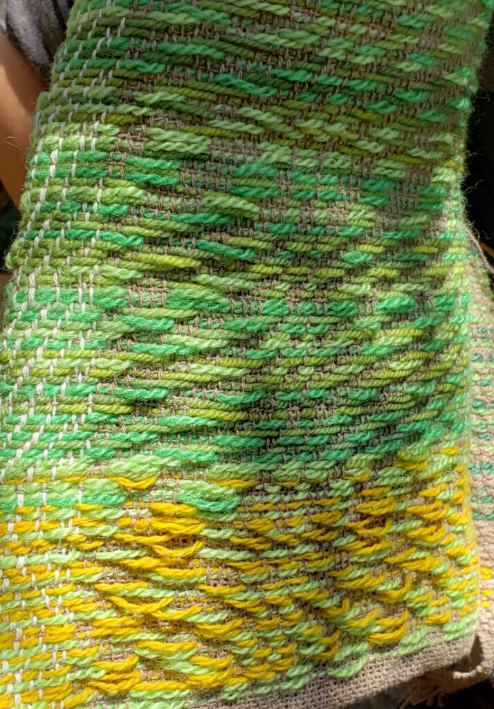 The inside surface of the vest, showing green and yellow highlights that are dominant on this surface.